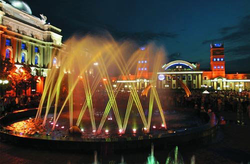 This is night view of local rail way station. Here you can observe beautiful fountain which looks like a real piece of creation and creates very positive atmosphere around.